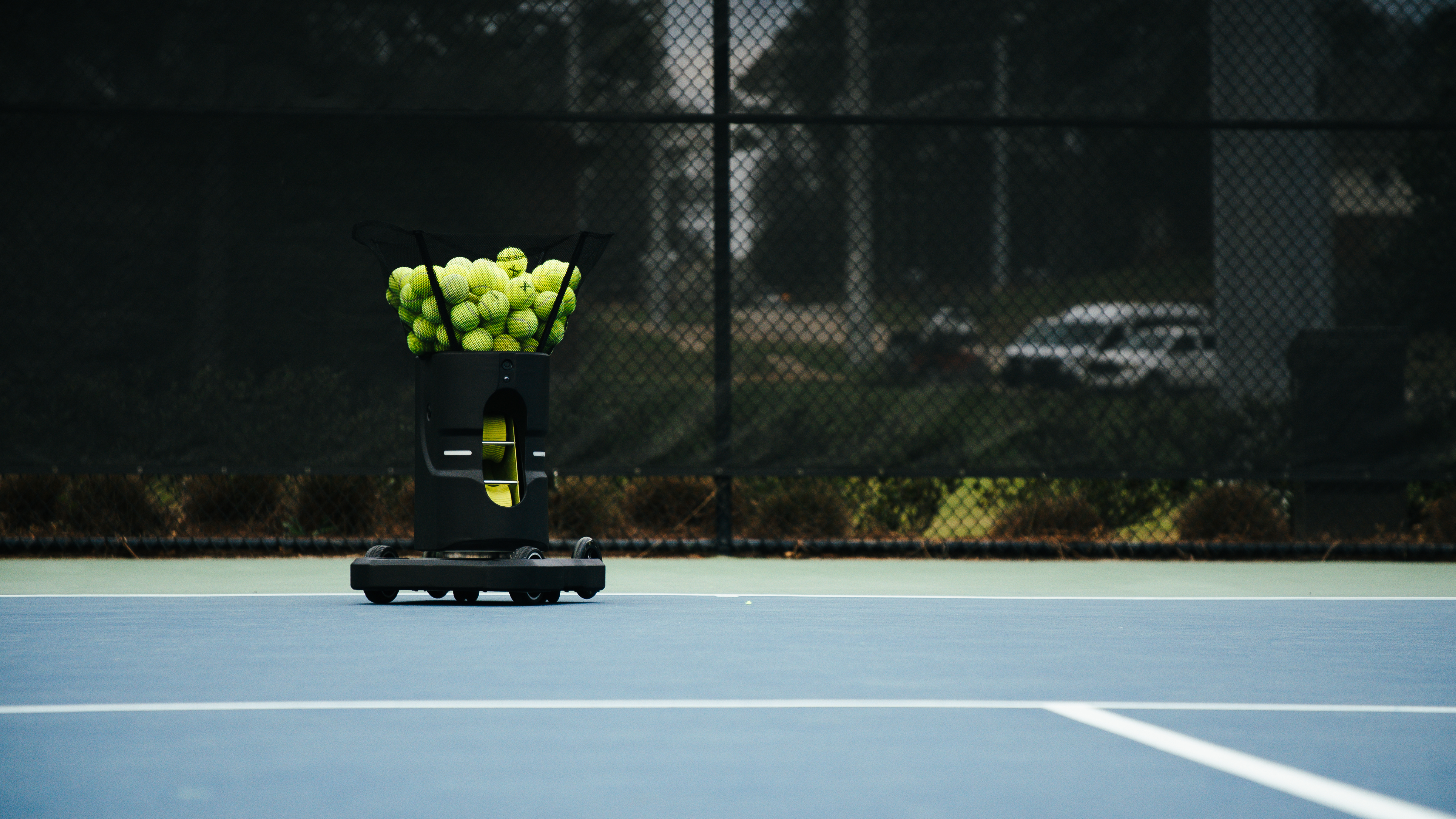 Tennibot Partner V2 stationary and mobile ball machine on court